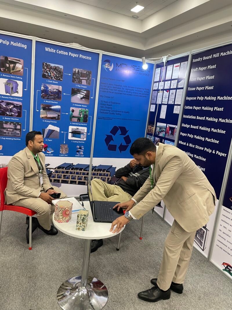 The MEW team discussing machinery at its exhibition stand